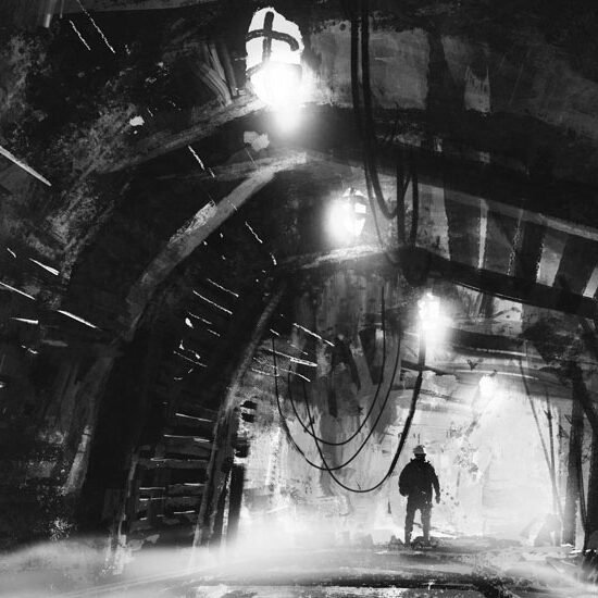 Silhouette of a man standing in the distance in an underground mine